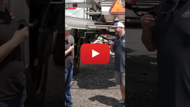 Overseeding cover crops into standing soybeans with a spreader truck